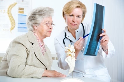 Elderly woman looking at her x-ray results with a doctor